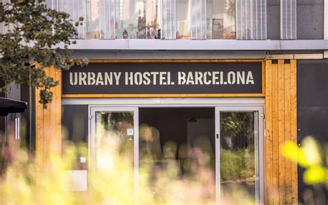 Thematic photo of a multi-story building entrance, suggesting an urban hostel, with a potential subtle focus on safety or lack thereof.