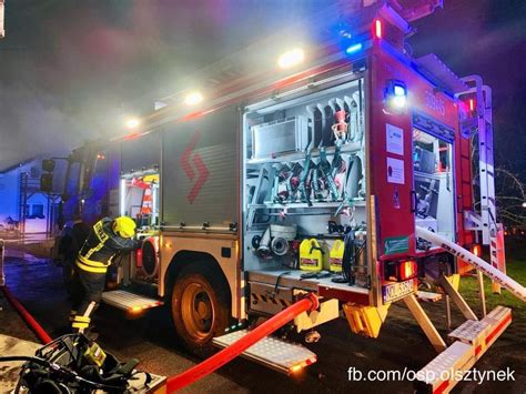 Photo of the handover ceremony for new fire trucks, showing OSP Bartąg representatives