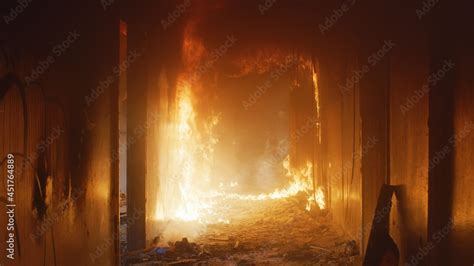 Thematic photo of a fire simulator in action, showing a person experiencing conditions inside a burning building under supervision.
