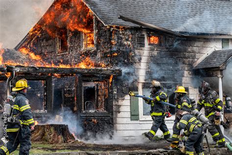Thematic photo of a house fire with firefighters