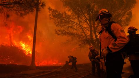 Aerial photo of firefighters battling a wildfire near residential areas in California