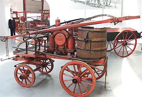 Historical photo of horse-drawn fire pump or early firefighters