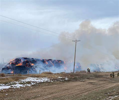 Aerial photo of a large haystack fire with multiple fire trucks