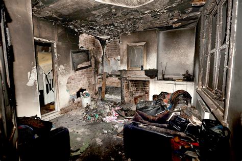 Thematic photo of a multi-family building after a fire, showing smoke damage or emergency services at the scene
