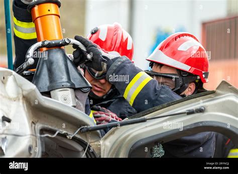 Thematic photo showing OSP firefighters conducting a rescue operation during a car accident, with an emphasis on teamwork