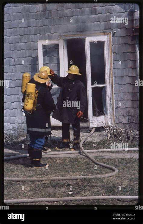 Thematic photo of firefighters at a library building, with visible smoke