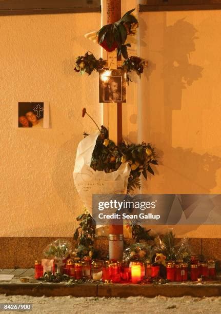 Photo of a makeshift memorial with a cross and candles