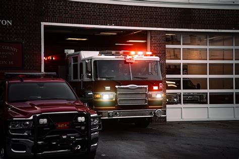 Thematic photo of a fire truck departing a fire station with flashing lights