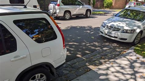 Photo of a car illegally parked blocking a fire station entrance