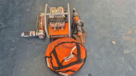 Photo of a Holmatro hydraulic rescue system, highlighting the jaws of life and spreader