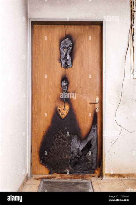 Thematic photo of a charred apartment door with smoke