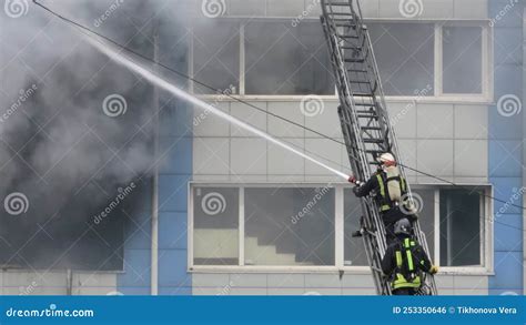 Thematic photo of firefighters extinguishing a large hall fire with heavy smoke