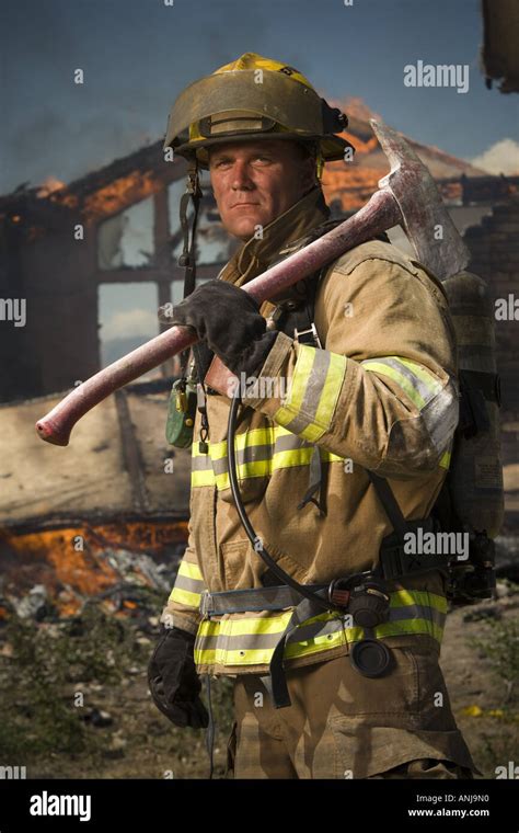 Thematic photo of a firefighter holding a specialized axe