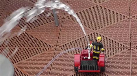 Thematic photo of a child playing with a toy fire truck with a water cannon