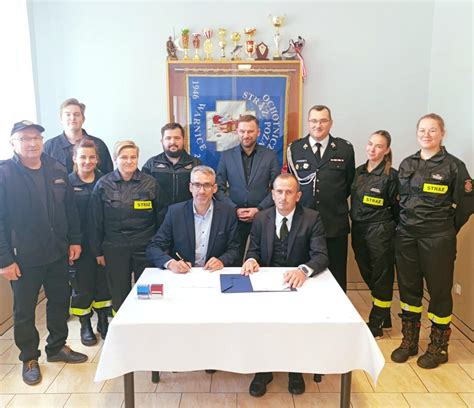 grupa strażaków OSP Jamielne z książką 