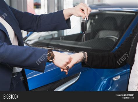 Photo of officials at a ceremony, handing over keys
